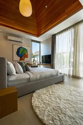 a bedroom with a large bed and a large window at Luxpride Villa by Wallaya Villas in Ban Thalat Choeng Thale