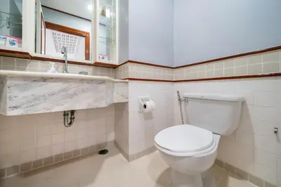 a bathroom with a white toilet and a window at The Lake Front Laguna Alla13 in Laguna Phuket