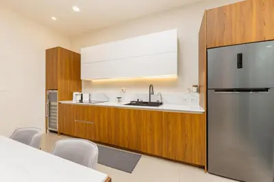 a kitchen with a sink and a refrigerator at Villa Aura 3BR Private Pool Near Naiharn Beach by TropicLook in Rawai Beach