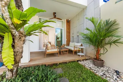 a house with a wooden deck with plants at Villa Aura 3BR Private Pool Near Naiharn Beach by TropicLook in Rawai Beach