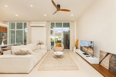 a living room with a white couch and a ceiling fan at Villa Aura 3BR Private Pool Near Naiharn Beach by TropicLook in Rawai Beach