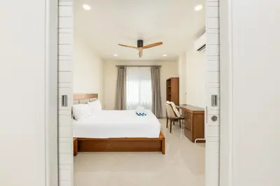 a bedroom with a bed and a desk at Villa Aura 3BR Private Pool Near Naiharn Beach by TropicLook in Rawai Beach