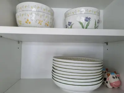 a shelf with plates and bowls on it at Ozone Condotel Kata Beach by Pitjira in Phuket Town