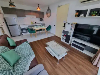 a living room with a couch and a table at Ozone Condotel Kata Beach by Pitjira in Phuket Town
