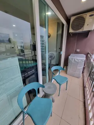 two blue chairs and a table on a balcony at Ozone Condotel Kata Beach by Pitjira in Phuket Town