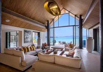 a large living room with couches and a large window at Villa Amaravida in Ko Lek