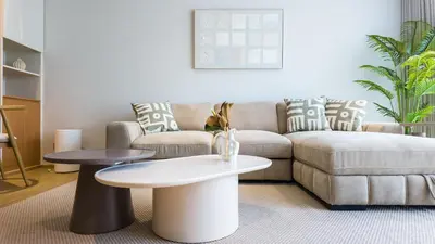 a living room with a couch and a table at BeachSide and SeaSide Residences Apartment 200 m to Bang Tao Beach in Bang Tao Beach