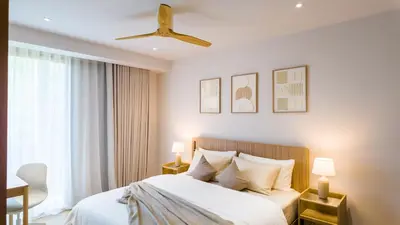 a bedroom with a bed and a ceiling fan at BeachSide and SeaSide Residences Apartment 200 m to Bang Tao Beach in Bang Tao Beach