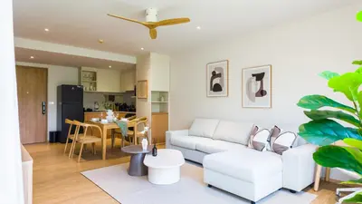 a living room with a white couch and a table at BeachSide and SeaSide Residences Apartment 200 m to Bang Tao Beach in Bang Tao Beach