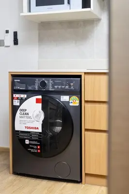 a black microwave oven sitting in a kitchen at Suite Azure 1BR Laguna Beachside Bang Tao Beach in Bang Tao Beach