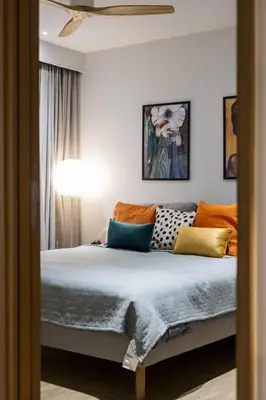 a bedroom with a bed with colorful pillows at Suite Azure 1BR Laguna Beachside Bang Tao Beach in Bang Tao Beach