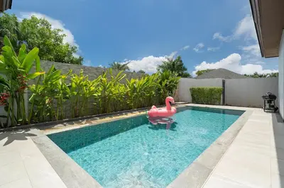 a swimming pool with a pink flamingo in the water at 5 minutes from Laguna - Private Pool 3BR in Laguna Phuket