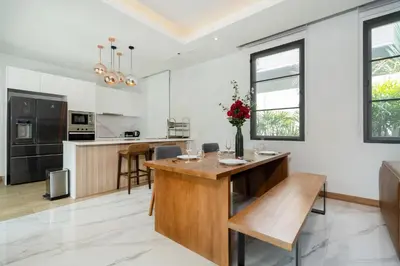 a kitchen with a wooden island in a room at 5 minutes from Laguna - Private Pool 3BR in Laguna Phuket