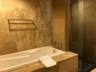 a bathroom with a bath tub and a shower at Bel Air Panwa Big Apartment in south Phuket near Ao Yon Beach, 3rd floor in Ban Ao Makham