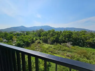 a view from the balcony of a house at IKON STAY Zcape 2 Condominium S in Bang Tao Beach