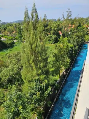 an aerial view of a swimming pool with trees at IKON STAY Zcape 2 Condominium S in Bang Tao Beach