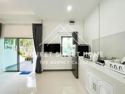 a kitchen with white counters and a large window at Naiharn Green Valley number 15 16 in Rawai Beach