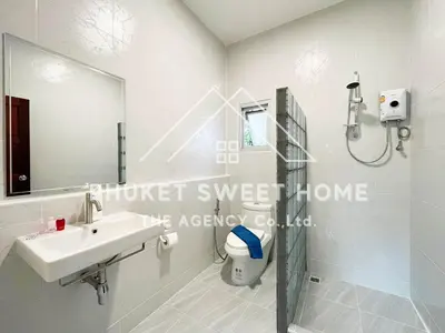 a white bathroom with a sink and a mirror at Naiharn Green Valley number 15 16 in Rawai Beach