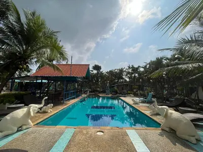 a swimming pool with statues of swans on it at Naiharn Green Valley number 15 16 in Rawai Beach
