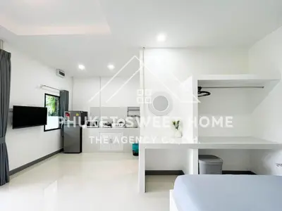 a white living room with a white desk and a kitchen at Naiharn Green Valley number 15 16 in Rawai Beach