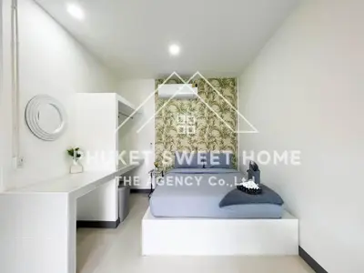 a bedroom with a bed and a desk at Naiharn Green Valley number 15 16 in Rawai Beach