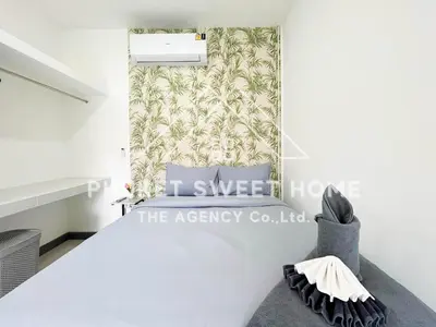 a bedroom with a bed and a wall at Naiharn Green Valley number 15 16 in Rawai Beach