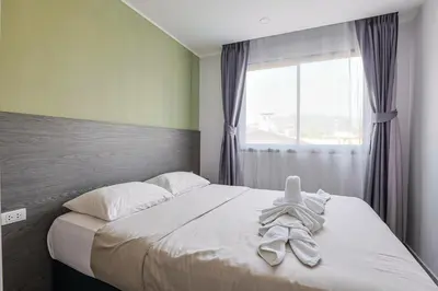 a bedroom with a bed with a towel on it at Big Buddha View - 1 bedroom T3 - 228 in Chalong