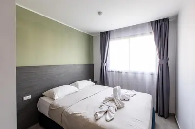 a bedroom with a bed with white sheets and a window at Big Buddha View - 1 bedroom T3 - 228 in Chalong