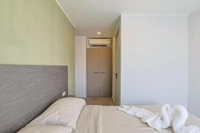 a bedroom with a bed with white sheets at Big Buddha View - 1 bedroom T3 - 228 in Chalong