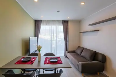 a living room with a table and a couch at Big Buddha View - 1 bedroom T3 - 228 in Chalong