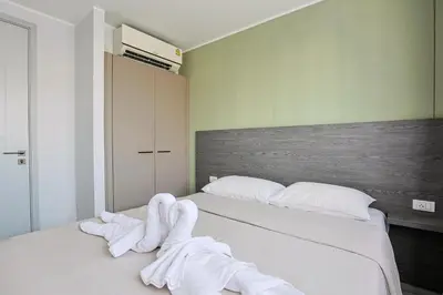 a bedroom with a bed with white towels on it at Big Buddha View - 1 bedroom T3 - 228 in Chalong