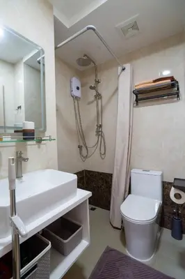 a bathroom with a sink and a shower and a toilet at Pool View Tropic Studio in Ban Mai Salae