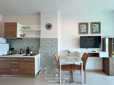 a kitchen with a table and chairs and a tv at Condo fodr rent The bell 50 in Ban Klang