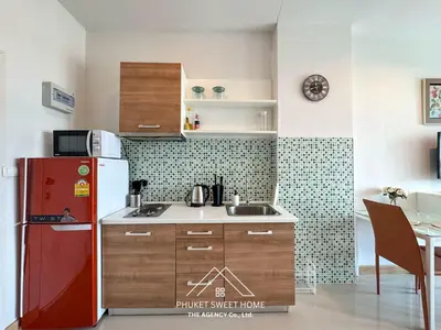 a kitchen with a red refrigerator and a table at Condo fodr rent The bell 50 in Ban Klang