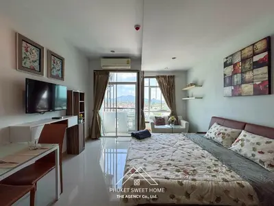 a bedroom with a bed and a desk and a television at Condo fodr rent The bell 50 in Ban Klang