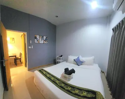 a bedroom with a large white bed in a room at Damiya Peaceful House in Ban Bo Dan