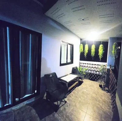 a room with two chairs and a table and some plants at Damiya Peaceful House in Ban Bo Dan