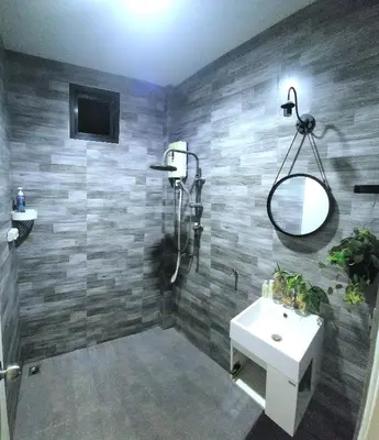 a bathroom with a shower and a sink and a mirror at Damiya Peaceful House in Ban Bo Dan