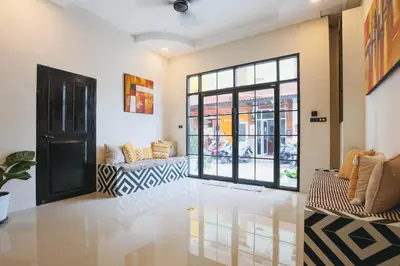 a living room with two couches and a window at Wink City 1 Patong Beach 4bedrooms in Patong Beach