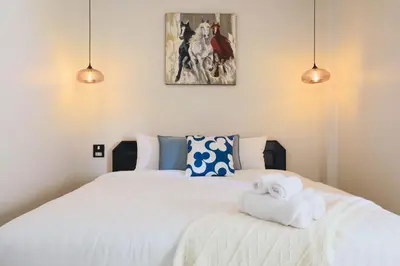 a bedroom with a bed with two towels on it at Wink City 1 Patong Beach 4bedrooms in Patong Beach