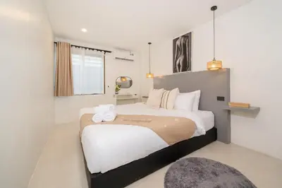 a bedroom with a large bed in a room at Wink Central 9 Patong Beach Phuket in Patong Beach
