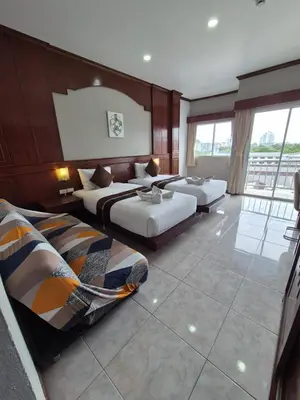 a hotel room with two beds and a balcony at New Forest Patong Hotel, Patong Beach in Patong Beach