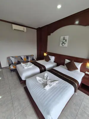a hotel room with two beds and avisor at New Forest Patong Hotel, Patong Beach in Patong Beach