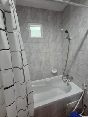 a bathroom with a tub and a shower curtain at New Forest Patong Hotel, Patong Beach in Patong Beach