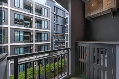 a balcony with a view of a building at Relife Kai 2 min to Nai Harn beach by TropicLook in Rawai Beach