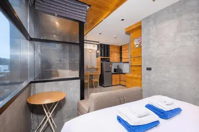 a kitchen and dining room with a table with towels at Relife Kai 2 min to Nai Harn beach by TropicLook in Rawai Beach