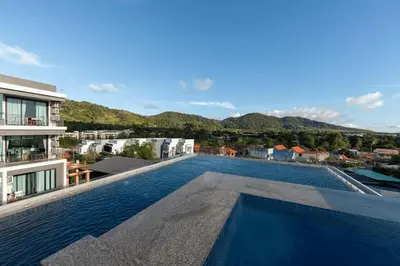 a swimming pool on the roof of a building at Relife Kai 2 min to Nai Harn beach by TropicLook in Rawai Beach