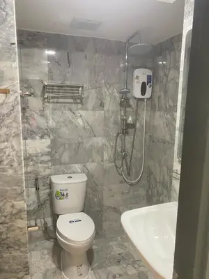 a bathroom with a shower and a toilet and a sink at май кхао Студия в кондо 777 in Koh Lone