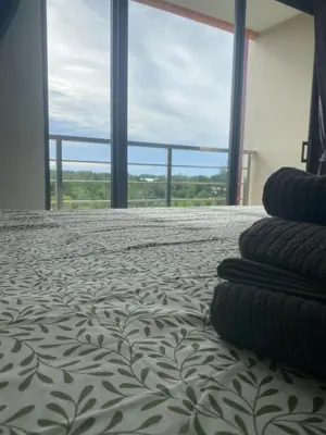 a bedroom with a bed with pillows on it at май кхао Студия в кондо 777 in Koh Lone