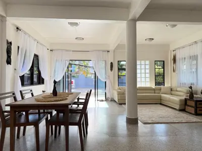 a living room with a table and a couch at Jungle style villa 3br in Kamala Beach
